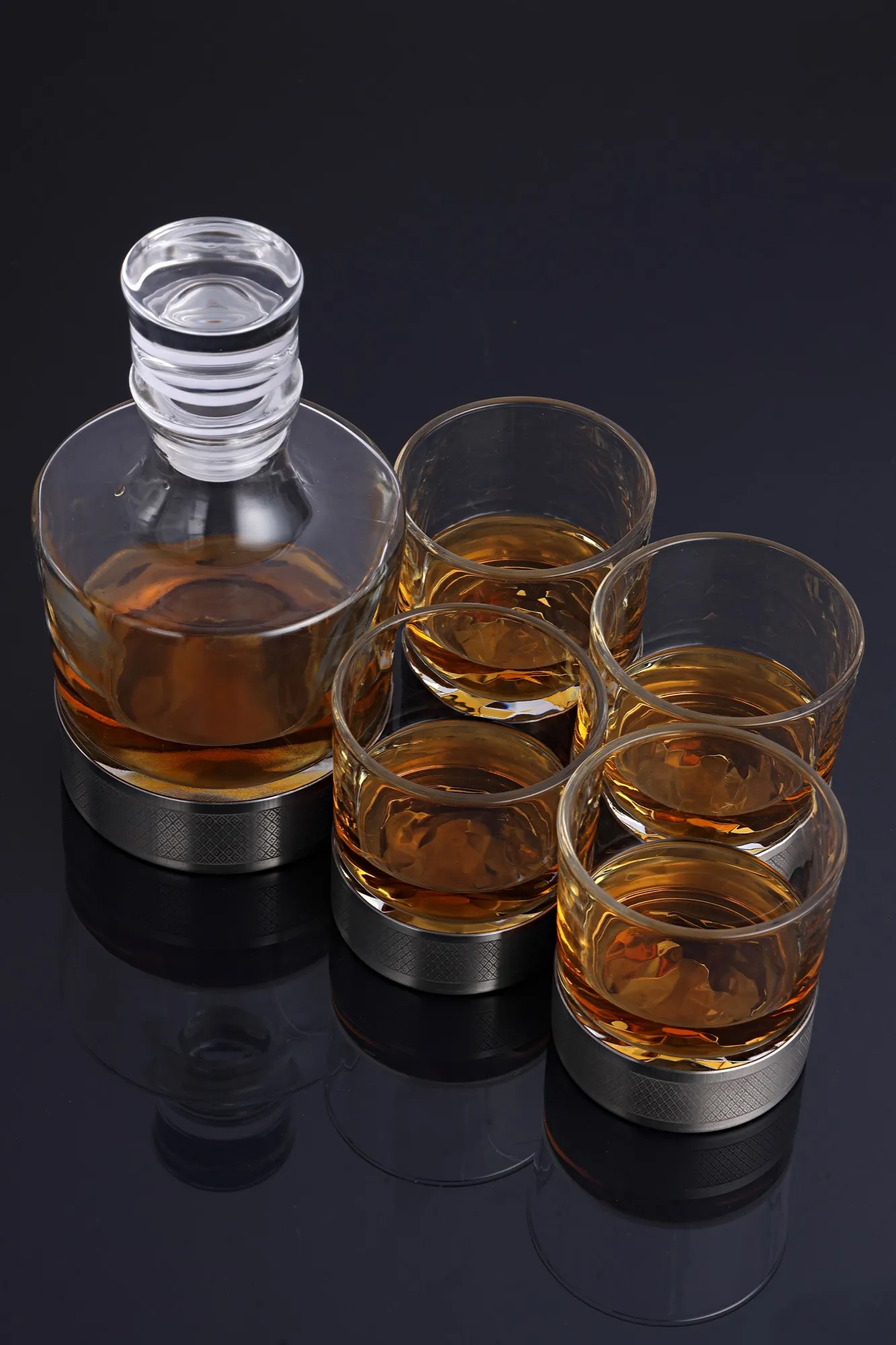 Decanter and four glasses clustered together, seen from above